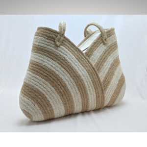 Handcrafted natural jute handbag featuring a minimalist two-tone woven design in earthy beige and cream tones, with soft-structured integrated handles and a clean organic texture.