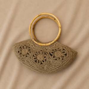 Short Description: A beautifully handcrafted natural jute handbag featuring a crescent-shaped silhouette, round bamboo-style handles, raised floral rope detailing, and a lined interior with zipper closure. Elegant, earthy, and perfect for brunch, summer outings, travel, or everyday statement styling.